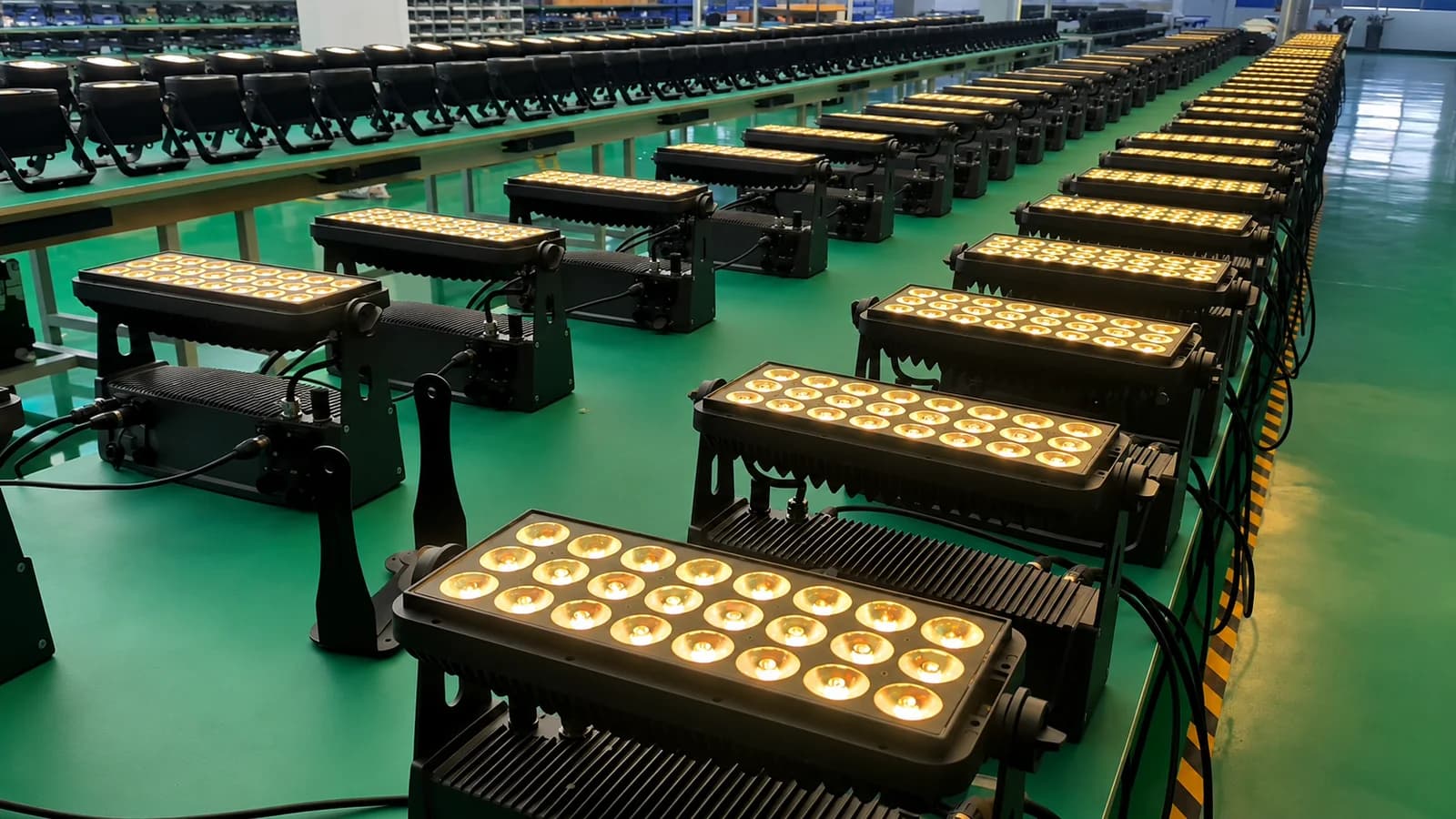 Rows of LumiUp battery lights undergoing a warm-white output test on the factory floor