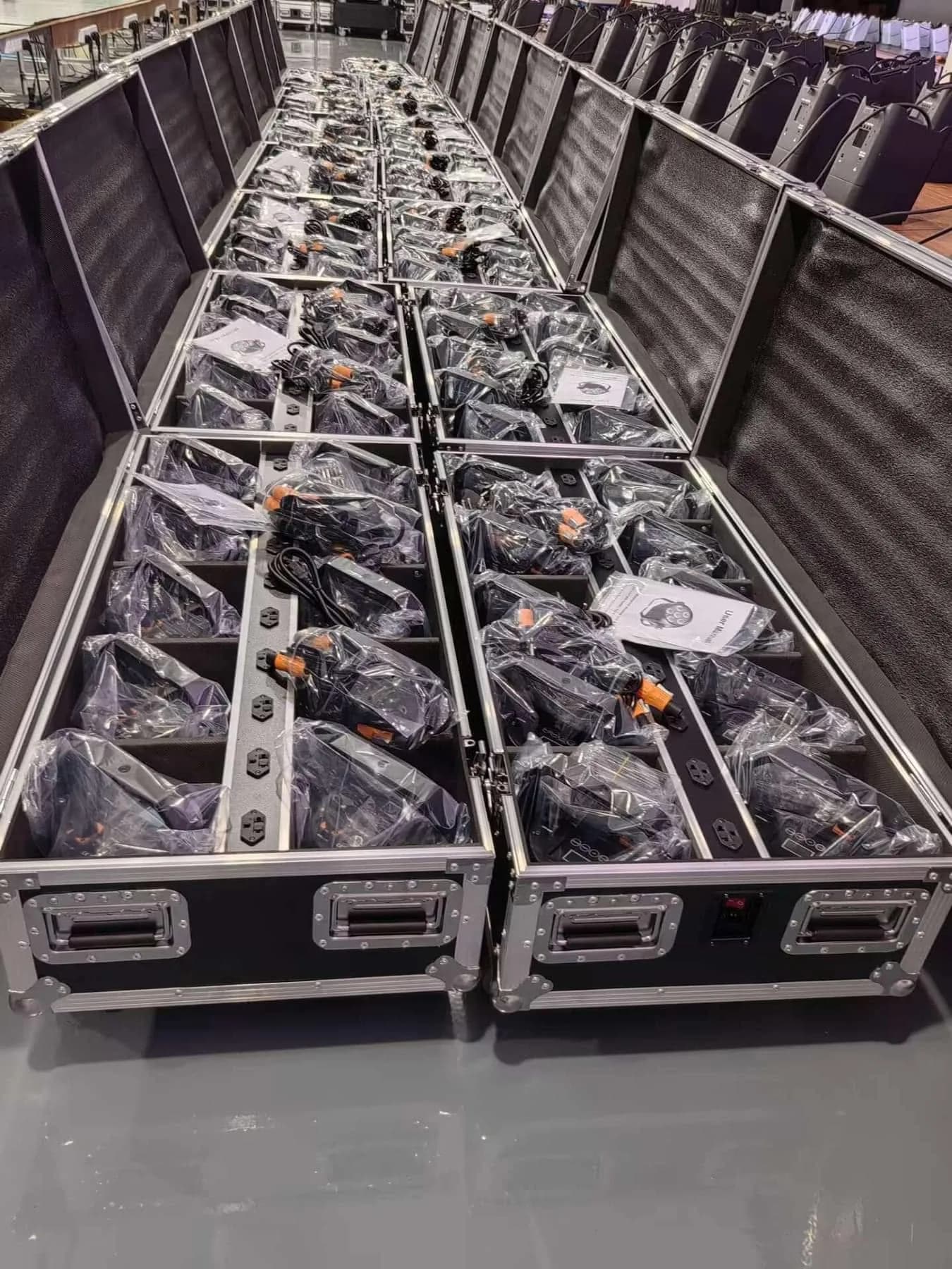 Battery LED PAR lights packed with power cables and manuals in protective flight cases