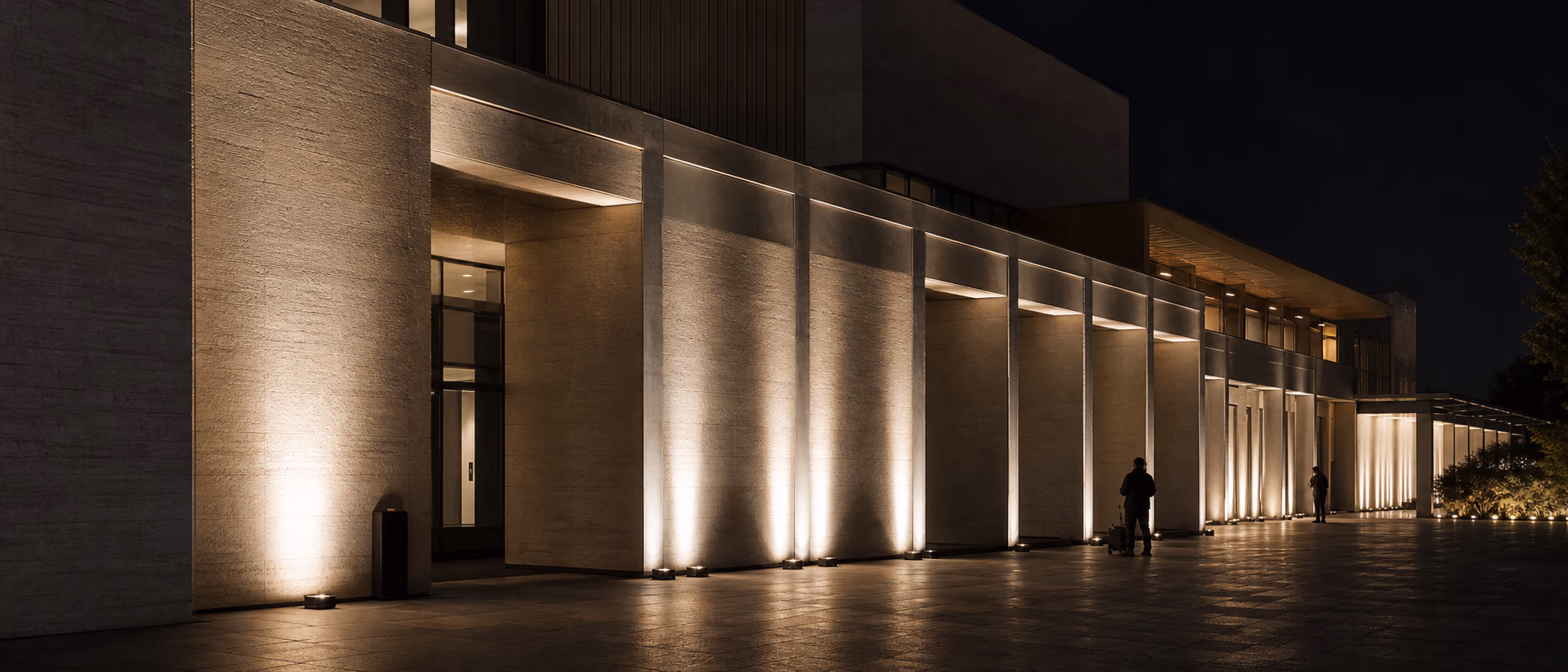 Museum façade illuminated with precise neutral-white and warm architectural uplights