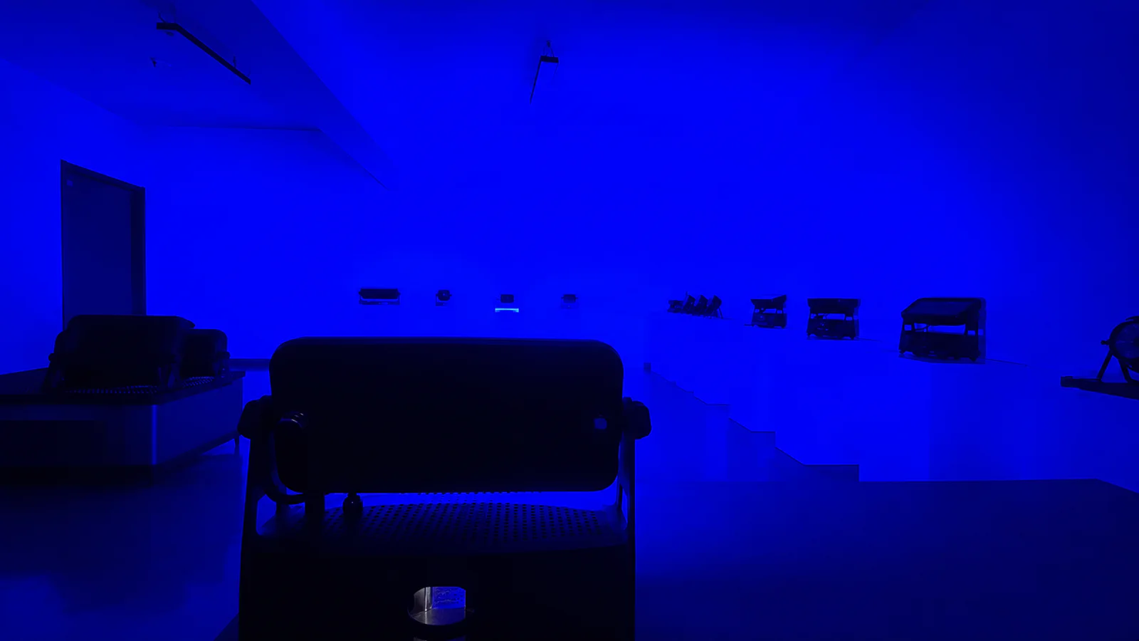 Blue-lit room used for a visual comparison of output from multiple stage lights