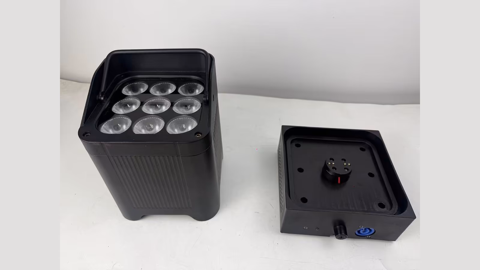 LumiUp Aqua P9X battery uplight beside its drop-in charging base