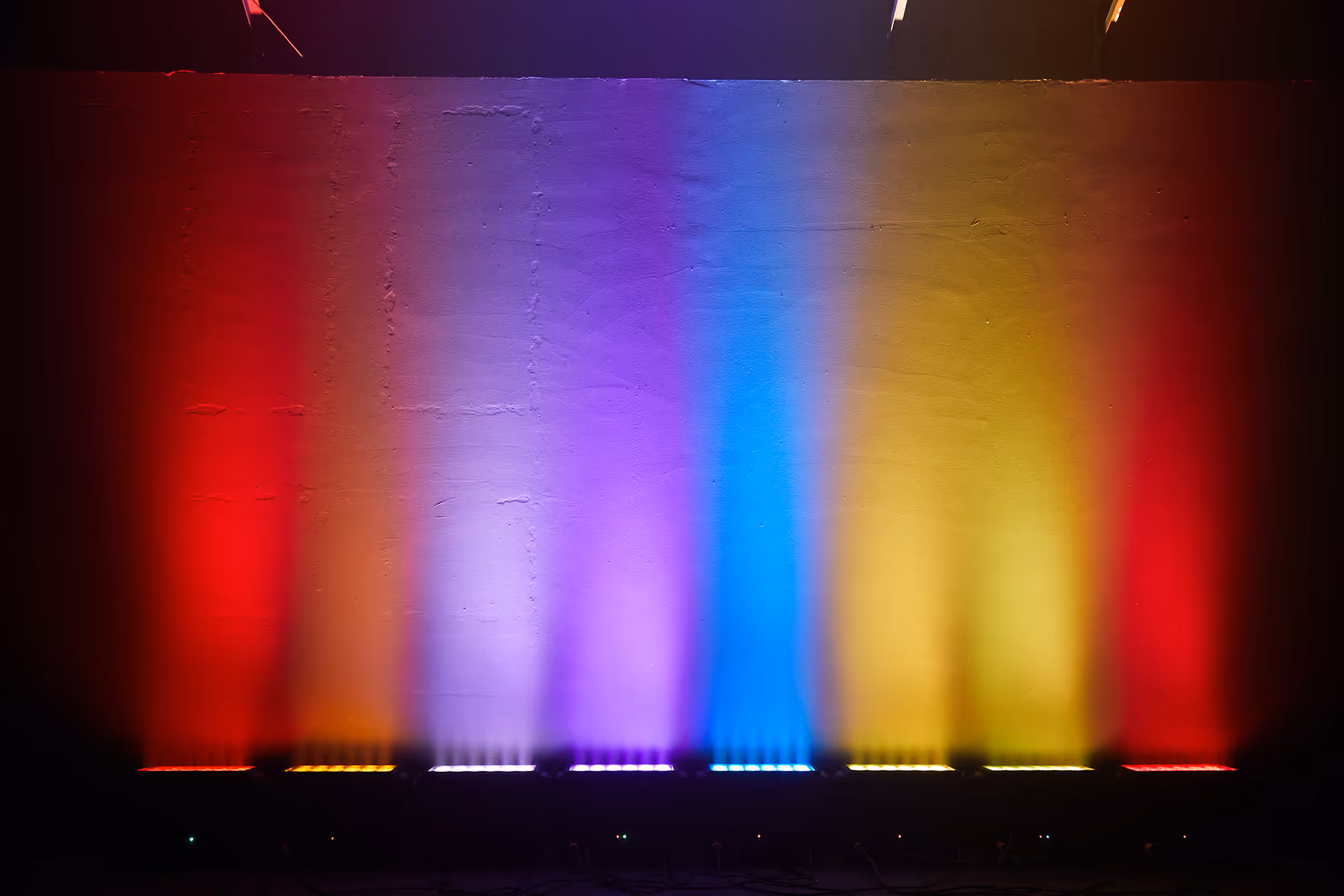 LumiUp battery uplights projecting multiple colors on a wall