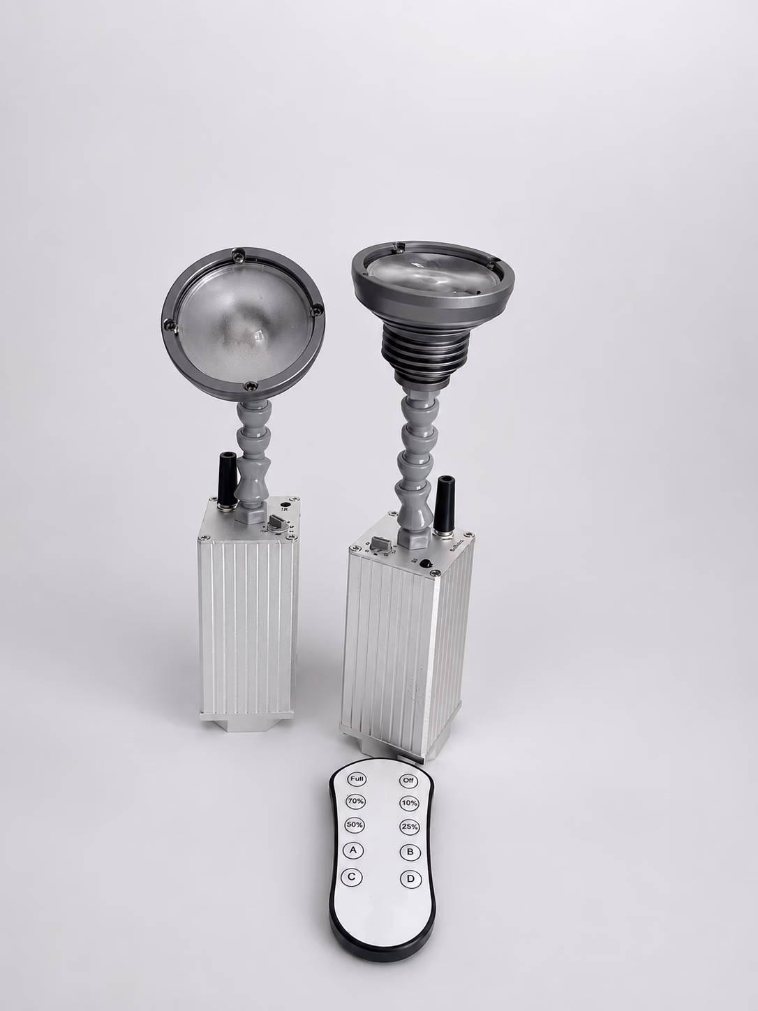 Two LumiUp Mini S1 battery pinspots shown with the infrared remote control